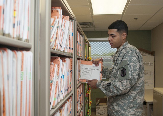 Pvt. Kendric Smith files military medical records. President Donald Trump signed an executive order Sept. 8 directing the Pentagon and VA to speed up the transfer of service members’ personnel and medical records. (U.S. Army photo)