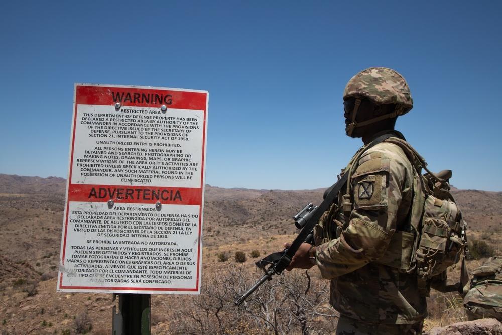 A U.S. Army soldier provides security beside a warning sign marking the New Mexico National Defense Area near Cloverdale, New Mexico, in May 2025. Three organizations filed a federal lawsuit October 8, 2026, challenging the transfer of approximately