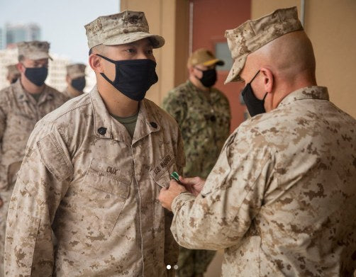 Illustrative file photo from a 2021 Marine Corps award ceremony. The Marine intelligence warrant officer featured in this story was later convicted of domestic violence and child endangerment and sentenced to two years in confinement under a plea