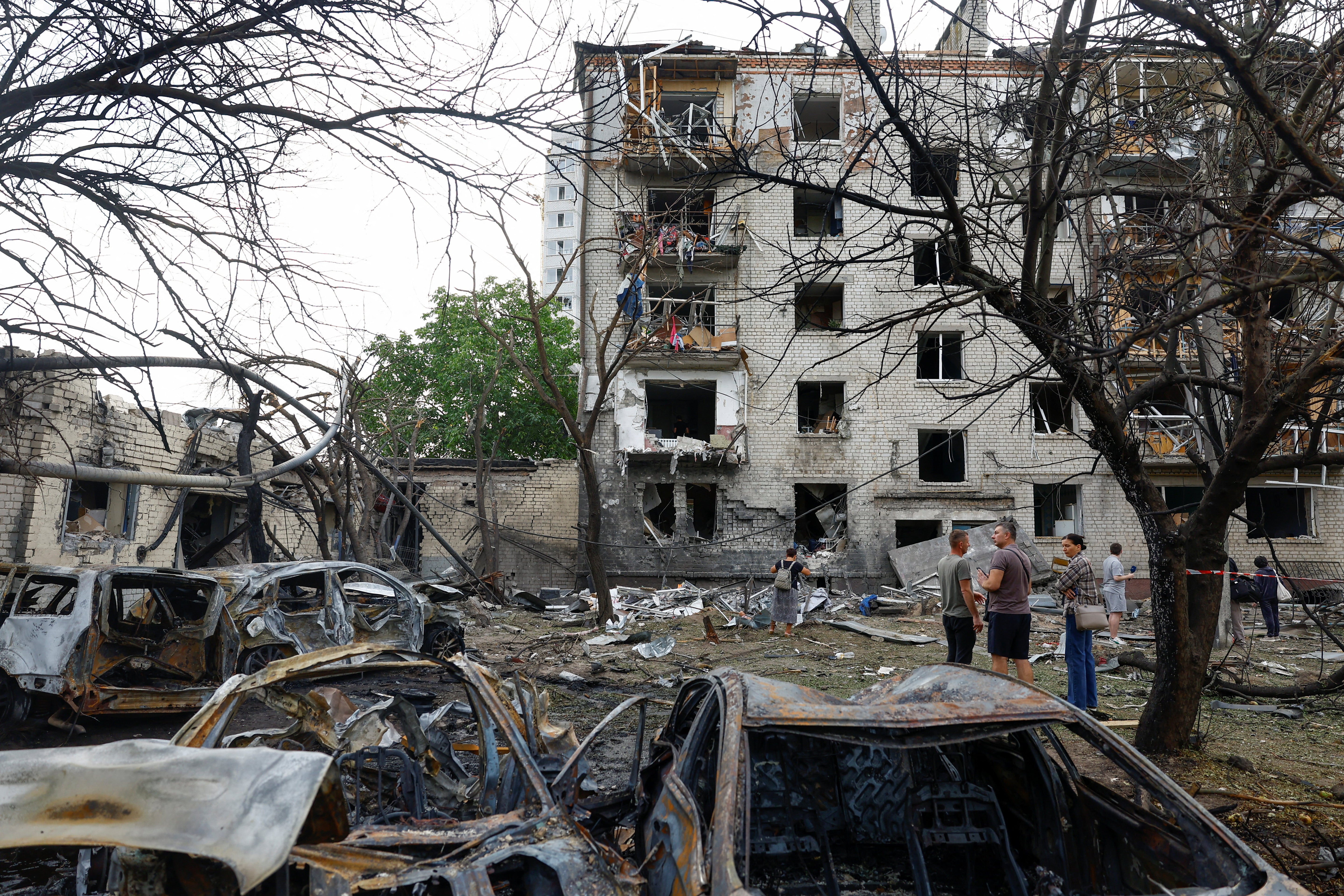 Residents stand in front of their apartment building damaged by a Russian missile strike in the town of Boryspil, amid Russia's attack on Ukraine, in Kyiv region, Ukraine September 1, 2026. REUTERS/Valentyn Ogirenko