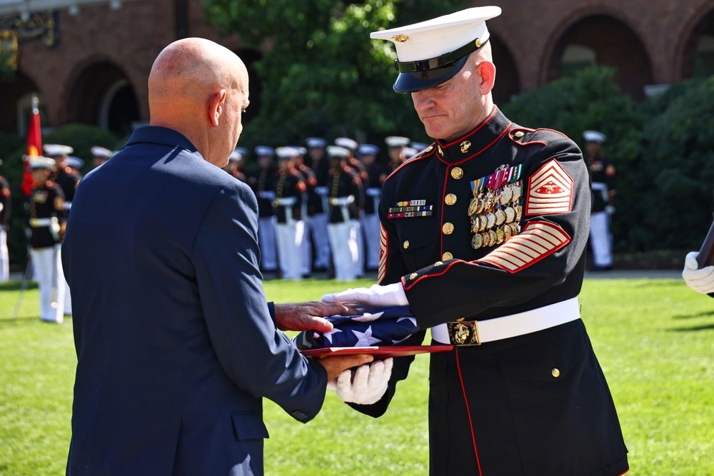 Sgt. Maj. Troy E. Black receives a folded American flag during his retirement ceremony at Marine Barracks Washington on June 20, 2025. Military retirees eligible for the standard adjustment are set to receive a 3.6% cost-of-living increase for 2027.
