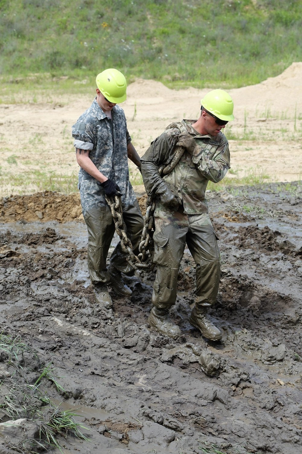 Illustrative file photo — Equipment Operator 3rd Class Jessie Canisalez, a U.S. Navy Seabee, crawls through a muddy trench during jungle warfare training in Okinawa, Japan, April 23, 2015. Sailors at Fleet Activities Sasebo are now being ordered to limit