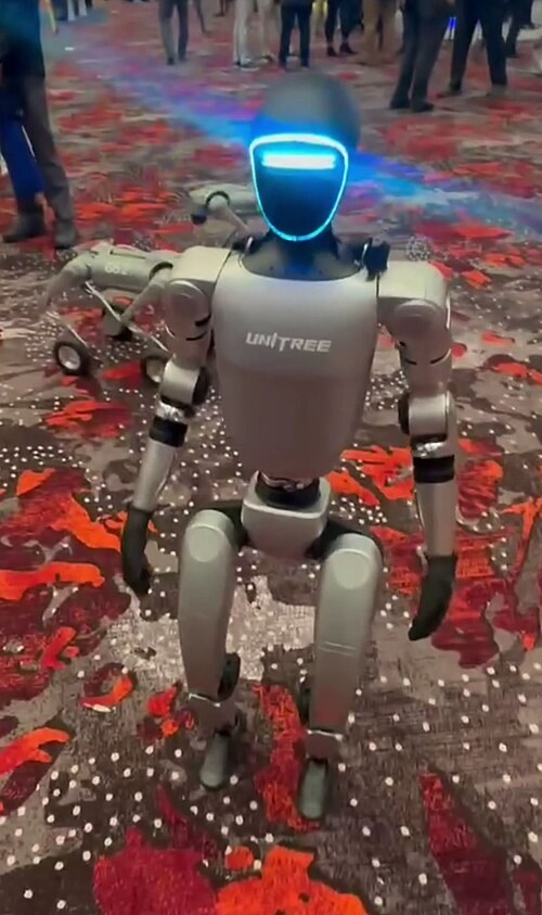 A Unitree G1 humanoid robot is displayed at UAV Expo 2024. The image is illustrative of China’s humanoid robotics industry and does not show an operational PLA combat deployment. (Photo by Sayanesy/Wikimedia Commons, CC0)