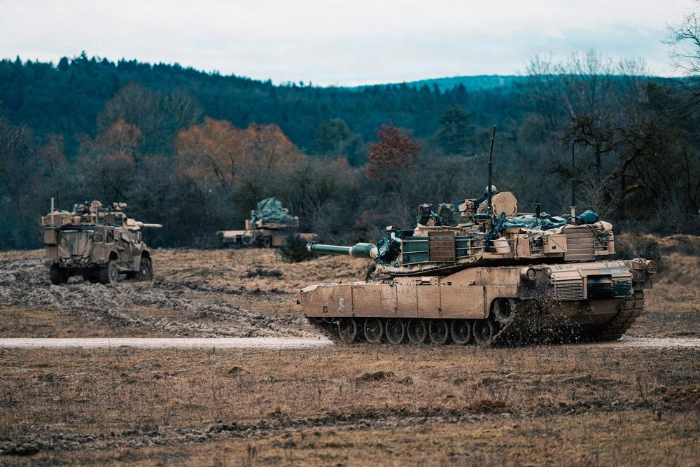 A U.S. Army M1 Abrams tank maneuvers during Exercise Combined Resolve at the Joint Multinational Readiness Center in Hohenfels, Germany, on February 22, 2026. During a separate October exercise at the same training area, Ukrainian soldiers worked