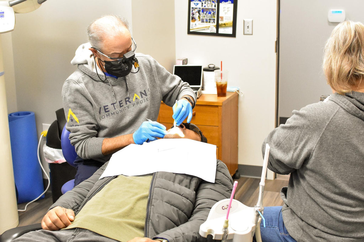 Dental professionals perform a tooth extraction during a Veterans Mission of Mercy clinic in Nebraska on November 15, 2024. New figures provided by VA show eligible veterans seeking an initial dental appointment wait an average of 51 days. U.S. Air Force