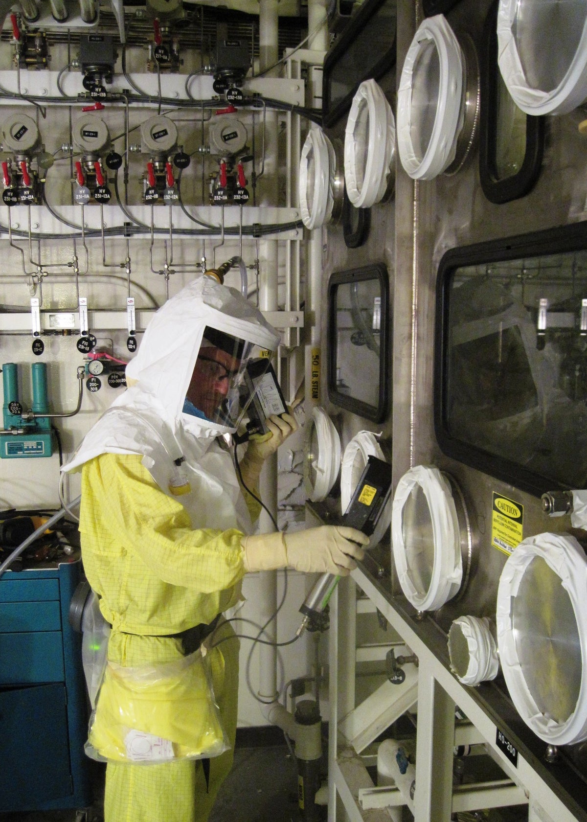 A worker wearing protective clothing handles equipment during cleanup operations at the Hanford nuclear site in Washington state on July 29, 2010. An October 2026 investigation by ProPublica and Cascade PBS found that the Department of Energy has filed