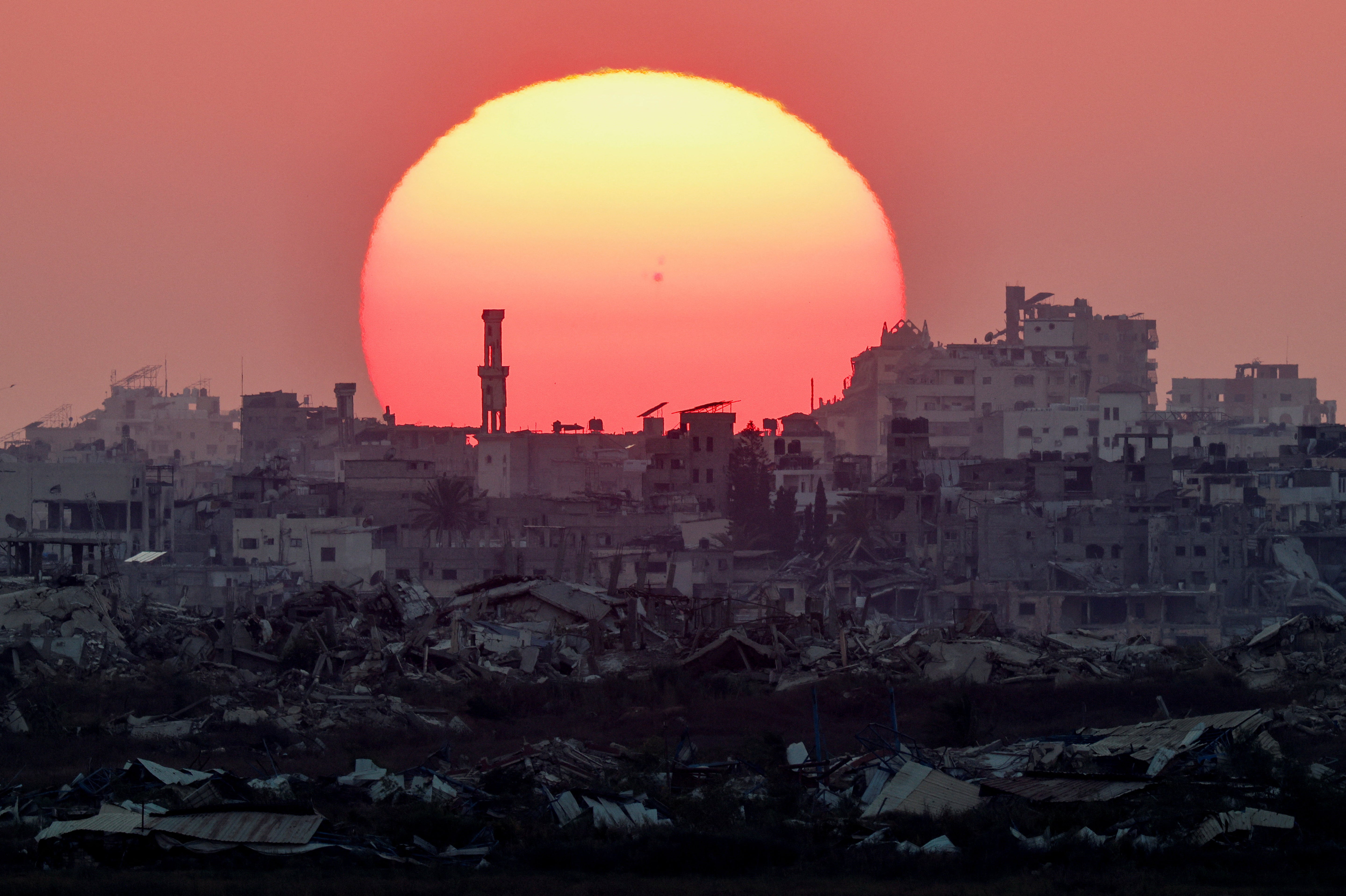The sun sets over Gaza, as seen from the Israeli side of the border, August 2, 2026. REUTERS/Amir Cohen
