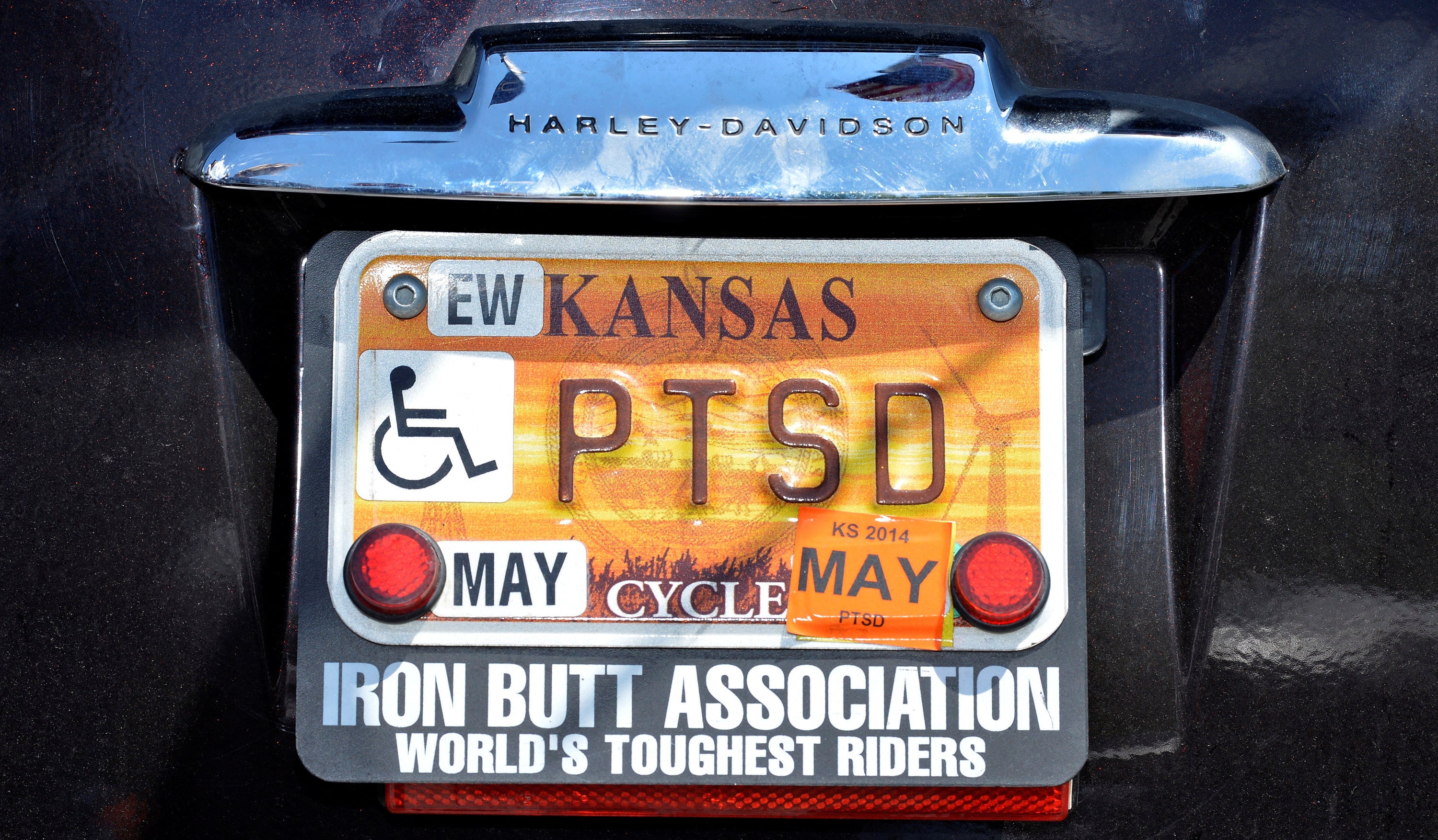 FILE PHOTO: Vietnam veteran Larry Edwards ,63, of Ellsworth, KS, sports a personal license plate "PTSD" for the Post Traumatic Stress Syndrome he still suffers for his service in Vietnam, as he arrives in Fairfax, Virginia May 25, 2013,  along with