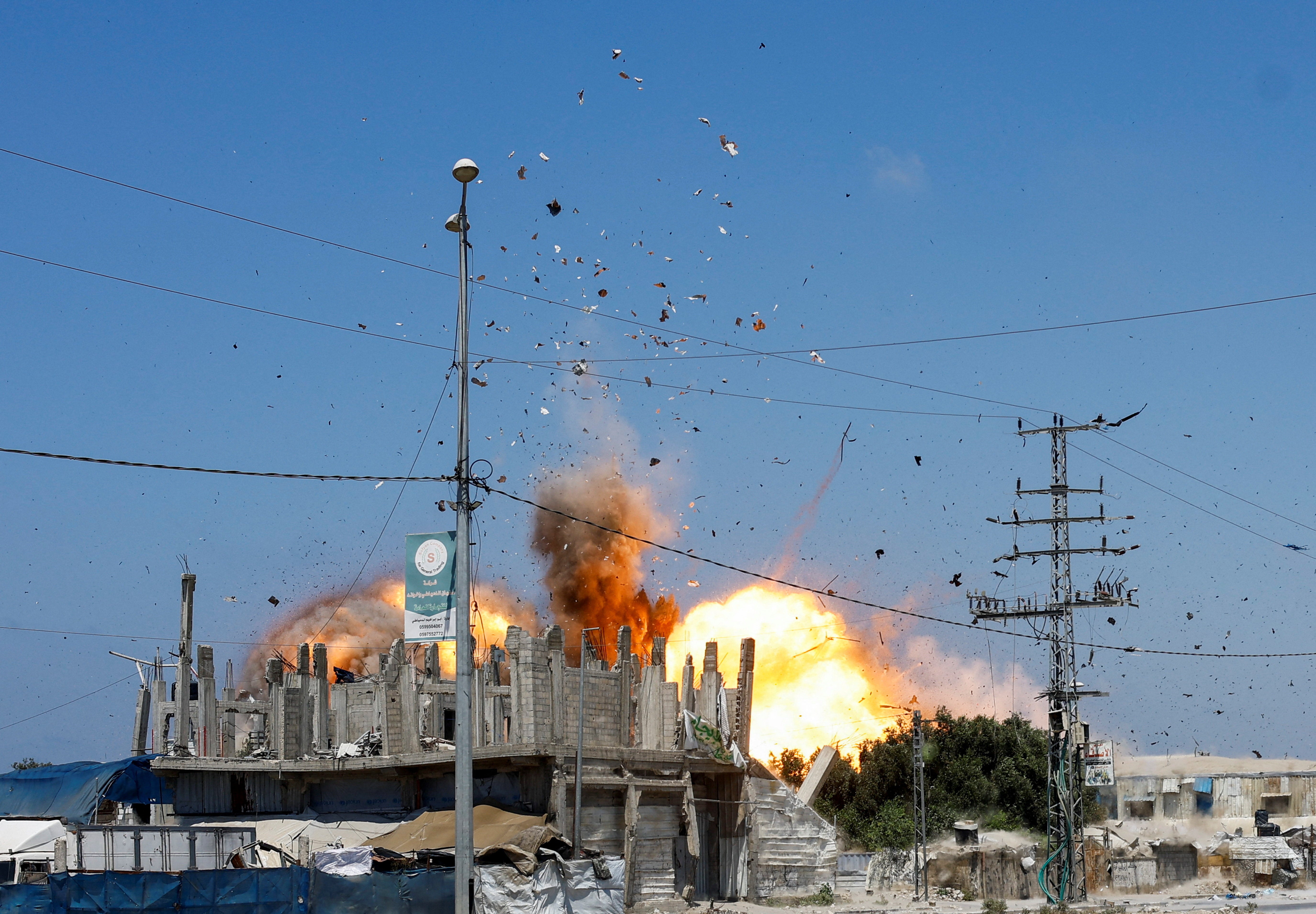 Debris flies through the air, during an Israeli strike, carried out after the Israeli military warned residents to evacuate the area, Al-Zawayda, in the central Gaza Strip,  August 23, 2026. REUTERS/Mahmoud Issa