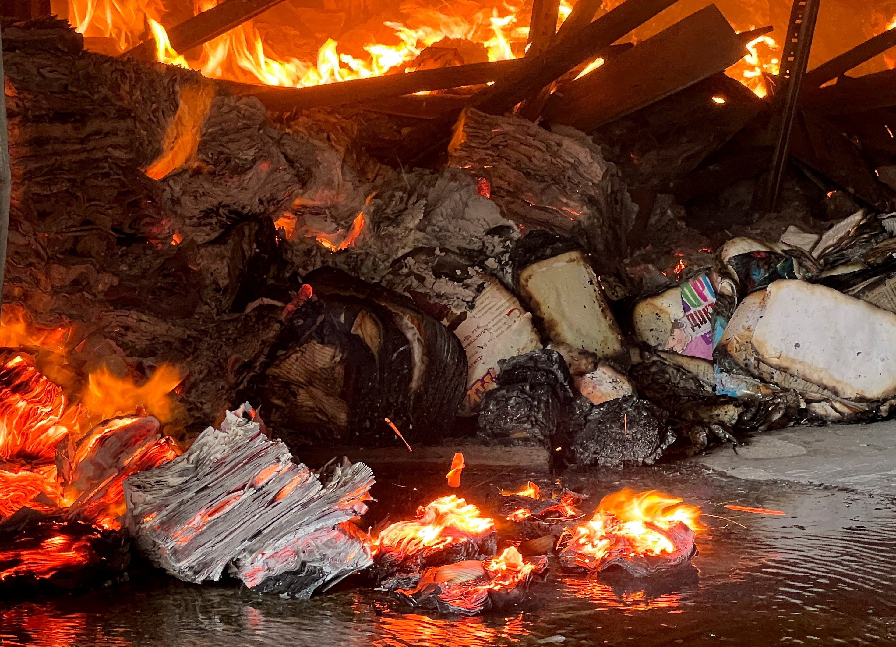 FILE PHOTO: Books burn at the site of a book warehouse hit by a Russian drone strike, amid Russia's attack on Ukraine, in Kharkiv, Ukraine, August 1, 2026. REUTERS/Volodymyr Pavlov/File Photo