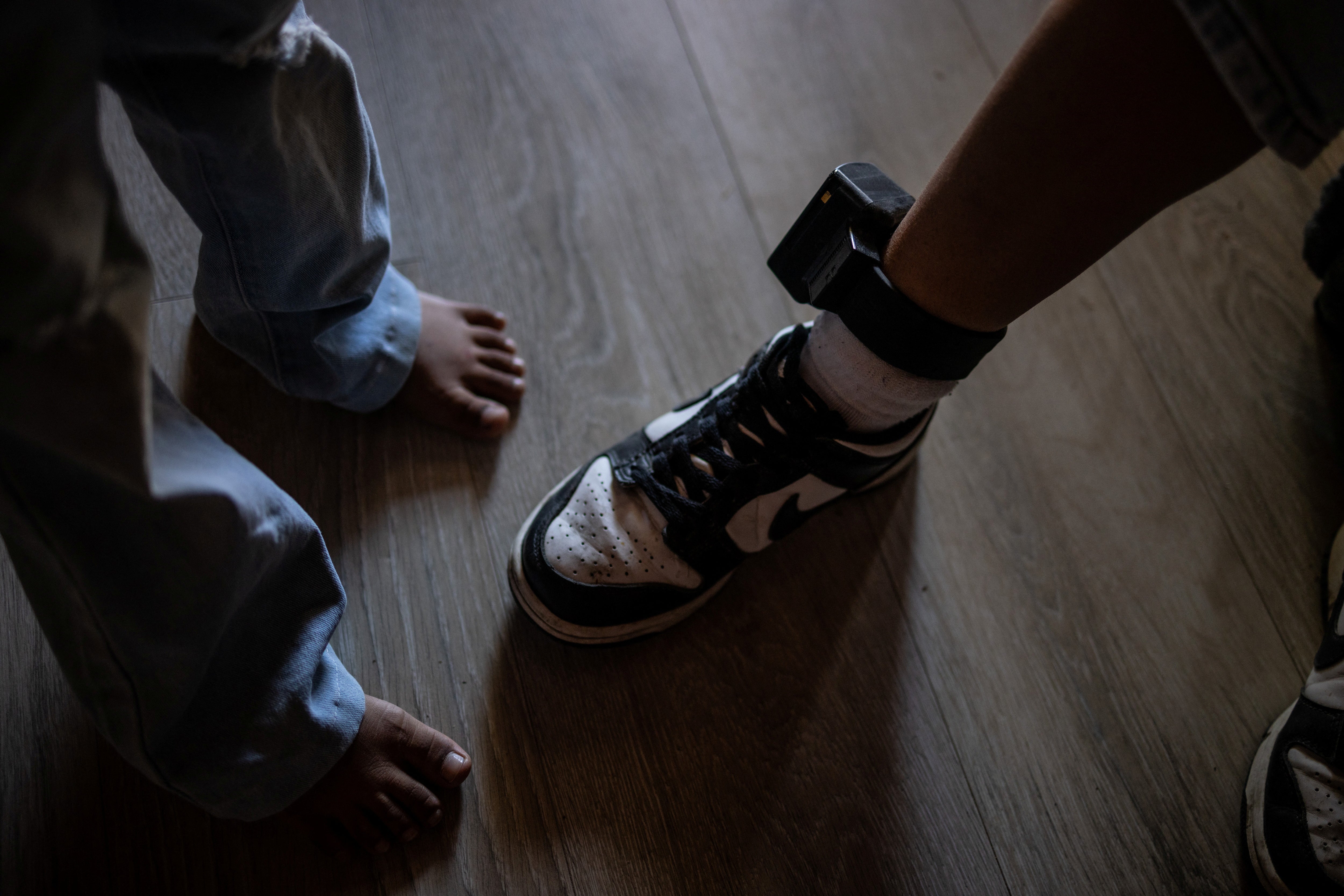 Aurora and her six-year-old daughter, who were detained by Immigration and Customs Enforcement and sent to a family detention center in Texas, pose for a portrait with Aurora’s ankle monitor during an interview with Reuters in the Central Valley of