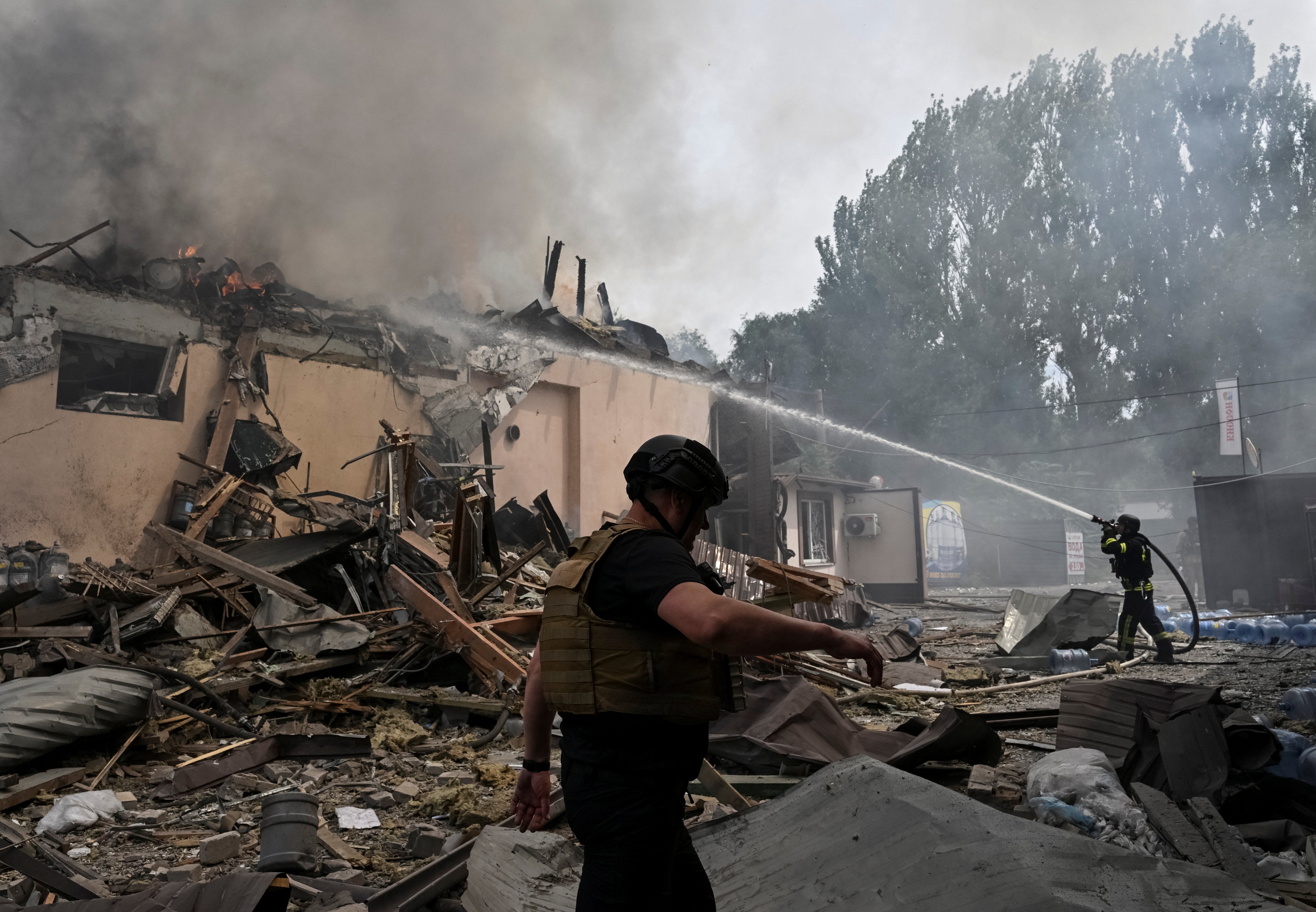 Rescuers work at a site of the drinking water delivery company hit by a Russian air strike, amid Russia's attack on Ukraine, in Zaporizhzhia, Ukraine July 25, 2026. REUTERS/Stringer