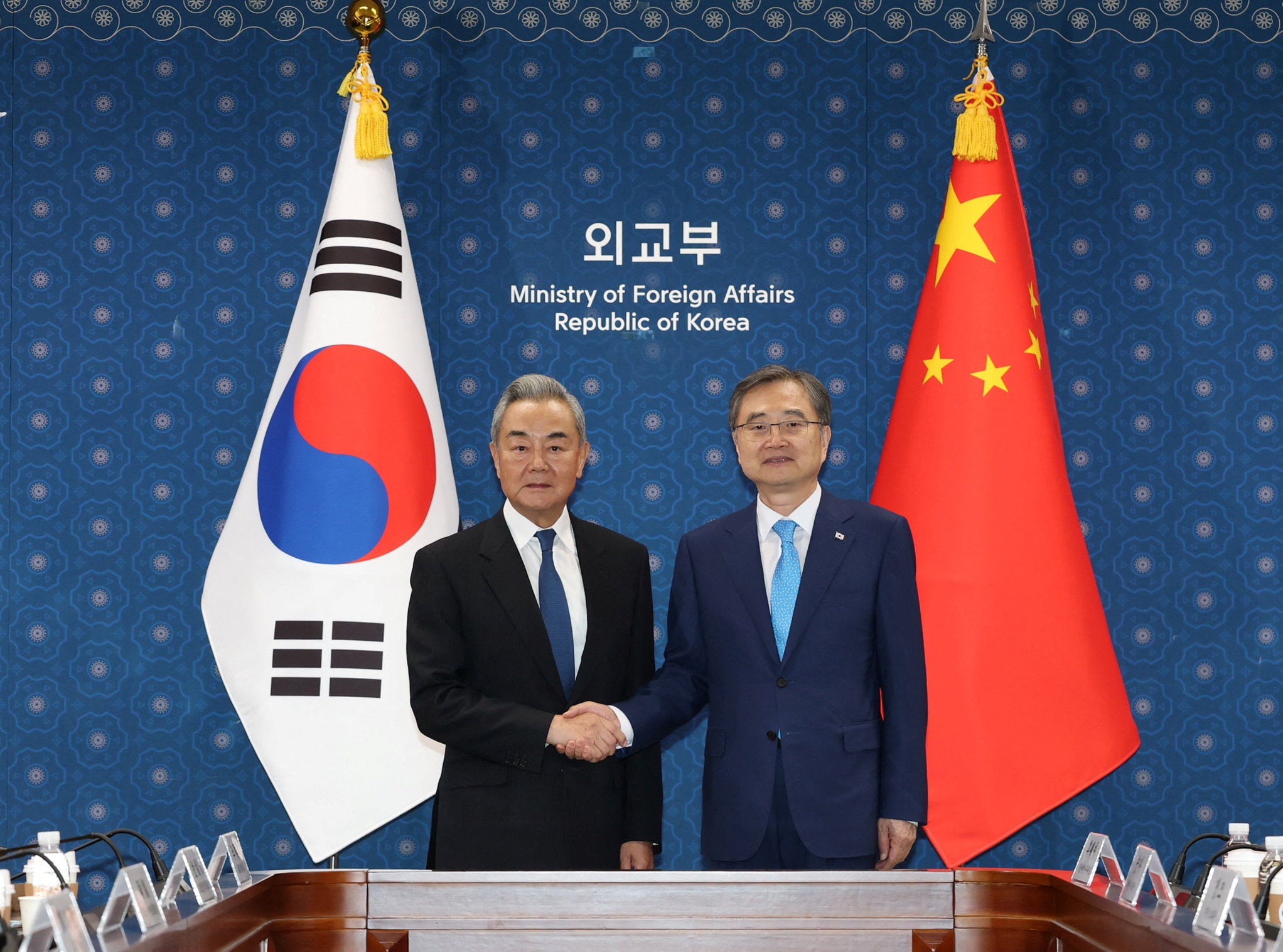 Chinese Foreign Minister Wang Yi shakes hands with his South Korean counterpart Cho Hyun during their meeting at the Foreign Ministry in Seoul, South Korea, August 19, 2026.   Yonhap via REUTERS