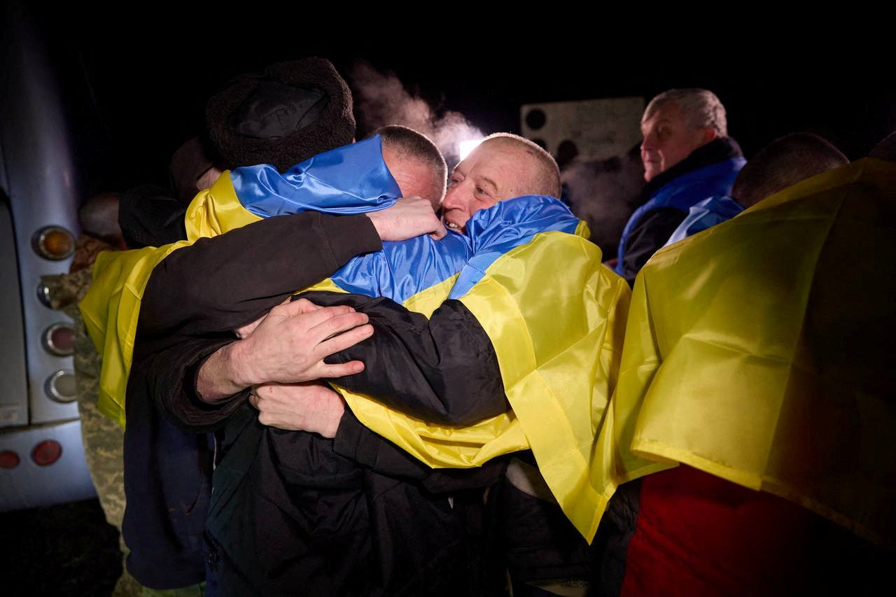 FILE PHOTO: Ukrainian prisoners of war (POWs) react after a swap, amid Russia's attack on Ukraine, at an unknown location in Ukraine, in this handout picture released January 3, 2024. Ukrainian Presidential Press Service/Handout via REUTERS/File Photo